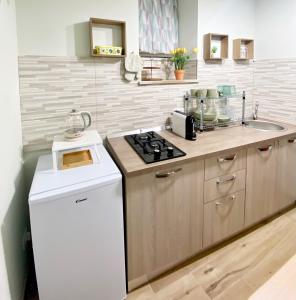 a kitchen with a sink and a stove top oven at La casa di Angela in Monreale