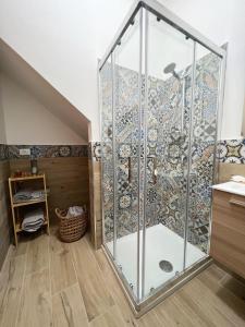 a shower with a glass door in a bathroom at La casa di Angela in Monreale