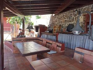 a patio with a table and chairs and a kitchen at The Palm Villa in Icod de los Vinos