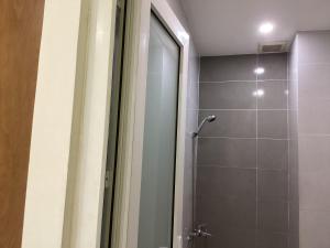 a bathroom with a shower with a glass door at KEIRA s HOUSE in Ho Chi Minh City