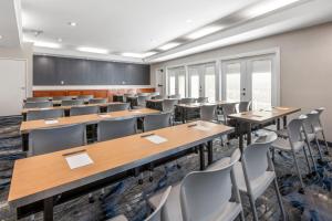 an empty classroom with tables and chairs at Fairfield Inn and Suites by Marriott San Jose Airport in San Jose