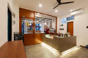 a kitchen with a counter and a counter top at Sans Hotel Suryakencana Bogor in Bogor