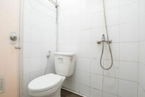 a bathroom with a toilet and a shower at Athena Syariah Residence in Tangerang