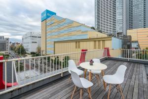a balcony with a table and chairs on a building at KYARA Hotel 白鳥 in Tokyo