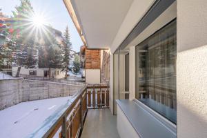 a balcony with a view of a snow covered mountain at Seventh Sky - the luxury apartment in Zermatt