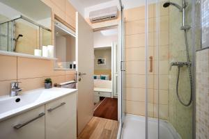 a bathroom with a shower and a sink at Olea Luxury Rooms in Split