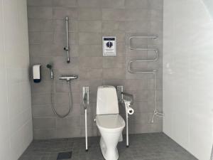 a bathroom with a toilet and a shower at Hotel Sleep at Rauma in Rauma