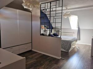a bedroom with a bed and a large mirror at Agréable maison de ville, en triplex in Blois