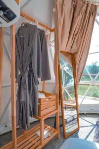 a mirror and a robe on a bunk bed at Heaven Hill Camping in Ban Thung Na
