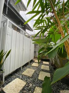 a walkway in a greenhouse with plants at LORENT HOSTEL Nipah in Padang