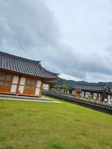a building with a grass field in front of it at Wonhwaroo in Gyeongju