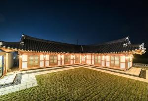 an asian building with a courtyard at night at Wonhwaroo in Gyeongju
