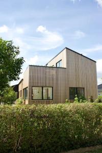 a large wooden building with windows on top of a field at House in beautiful Copenhagen in Copenhagen