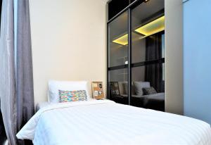 a bedroom with a bed and a large mirror at Expressionz Professional Suites Kuala Lumpur in Kuala Lumpur