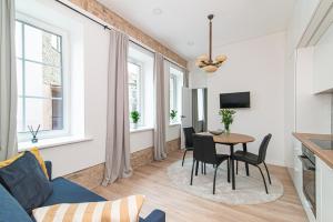 a living room with a blue couch and a table at New & Stylish Old Town Apartment by URBAN RENT in Vilnius