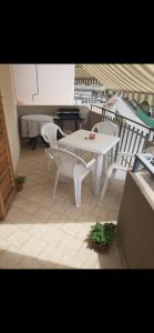 a white table and chairs on a balcony at Casavacanze Onda Blu in Mascali