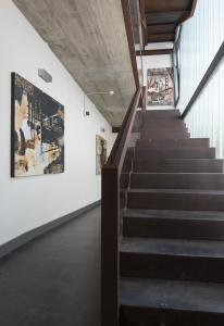 a staircase in a building with a painting on the wall at Hostal Emeritae in Mérida