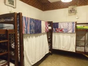 two sets of bunk beds in a room with quilts at Paraiso Hostel Moalboal in Moalboal