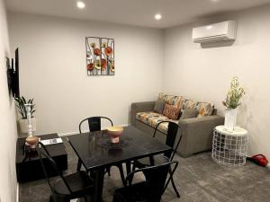 a living room with a table and a couch at 2 Bedroom Unit in Queenstown in Frankton Wharf