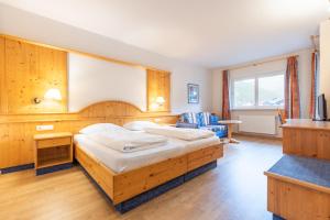 a bedroom with a large bed in a room at Hotel Central in Nova Levante