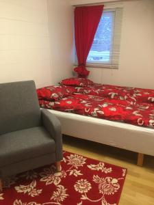 a bedroom with a bed and a chair and a window at Aurora Center 3 in Rovaniemi