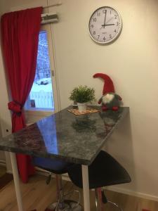 a table with a santa hat on top of it with a clock at Aurora Center 3 in Rovaniemi