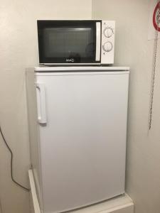 a microwave sitting on top of a white refrigerator at Aurora Center 3 in Rovaniemi