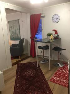 a living room with a table and two bar stools at Aurora Center 3 in Rovaniemi