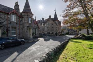 a car parked in front of a large building at The Bank House at Scotland's Hotel in Pitlochry