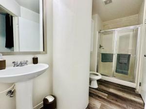 a white bathroom with a sink and a toilet at 2 BR Contemporary Modern Loft in Indianapolis