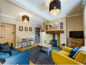 a living room with a couch and a table at Victoria Cottage in Barnard Castle