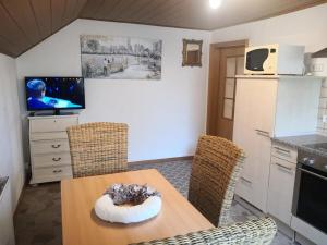 a kitchen with a table and chairs and a television at Landhaus Ferien Sommer in Bleckede