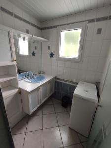 a small bathroom with a sink and a toilet at Pascanono - Location de maison de vacances avec jardin pour séjour à Le Palais, Belle-Ile-en-mer in Le Palais +24 photos