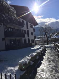 a snow covered yard in front of a building at Carè Alto in Carisolo