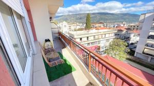 a balcony with two chairs and a view of a city at Antonia's city apartment in Ioannina
