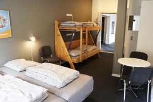 a room with two bunk beds and a table at Danhostel Haderslev in Haderslev