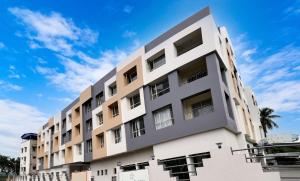 a white building with a blue sky in the background at Starlit Suites Newtown Kolkata in kolkata