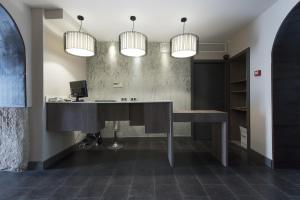 a desk in a room with two lights at Hostal Emeritae in Mérida