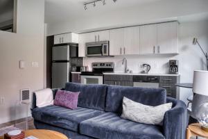 een woonkamer met een blauwe bank en een keuken bij Interbay jr 1br w lounge nr coffee bars SEA-649 in Seattle