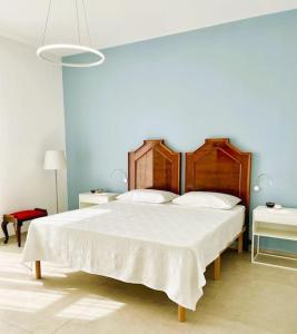 a bedroom with a large bed with a white blanket at L'Ancora appartamenti 3 in Giovinazzo