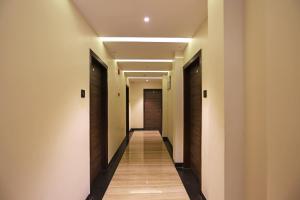 a hallway of a hotel with wooden floors and ceilings at Niharika Guest House in Guwahati