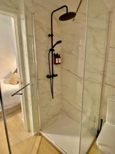 a shower with a glass door in a bathroom at Auditorio/Bernabéu Apartment2 in Madrid