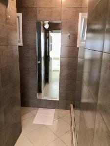 a bathroom with a shower with a mirror at Casa Verde Women Only in Casablanca +3 photos