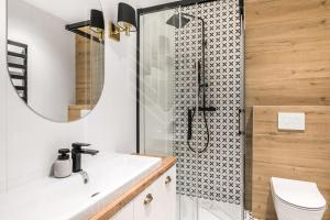 a bathroom with a shower with a sink and a toilet at Rent like home - Pod Blachówką 3 in Kościelisko