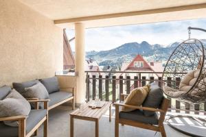 a balcony with chairs and a view of mountains at Rent like home - Pod Blachówką 3 in Kościelisko