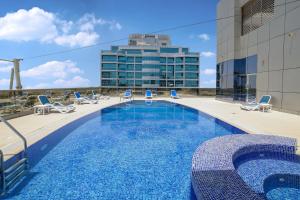 a swimming pool on the roof of a building at Spirit Tower - 1BR Apartment - Allsopp&Allsopp in Dubai