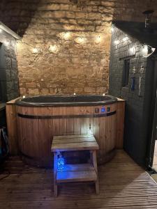 a wooden bath tub with a bench in a room at Victoria Cottage in Barnard Castle