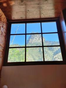 a window in a room with a view of a mountain at Tamahuche Hotel Rural in Vallehermoso