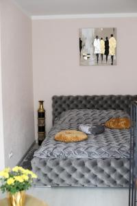 a bed with pillows on it in a bedroom at Dzintara apartamenti in Kuldīga