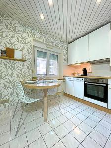 a kitchen with a table and chairs in it at Promenade de la Digue in Verdun-sur-Meuse